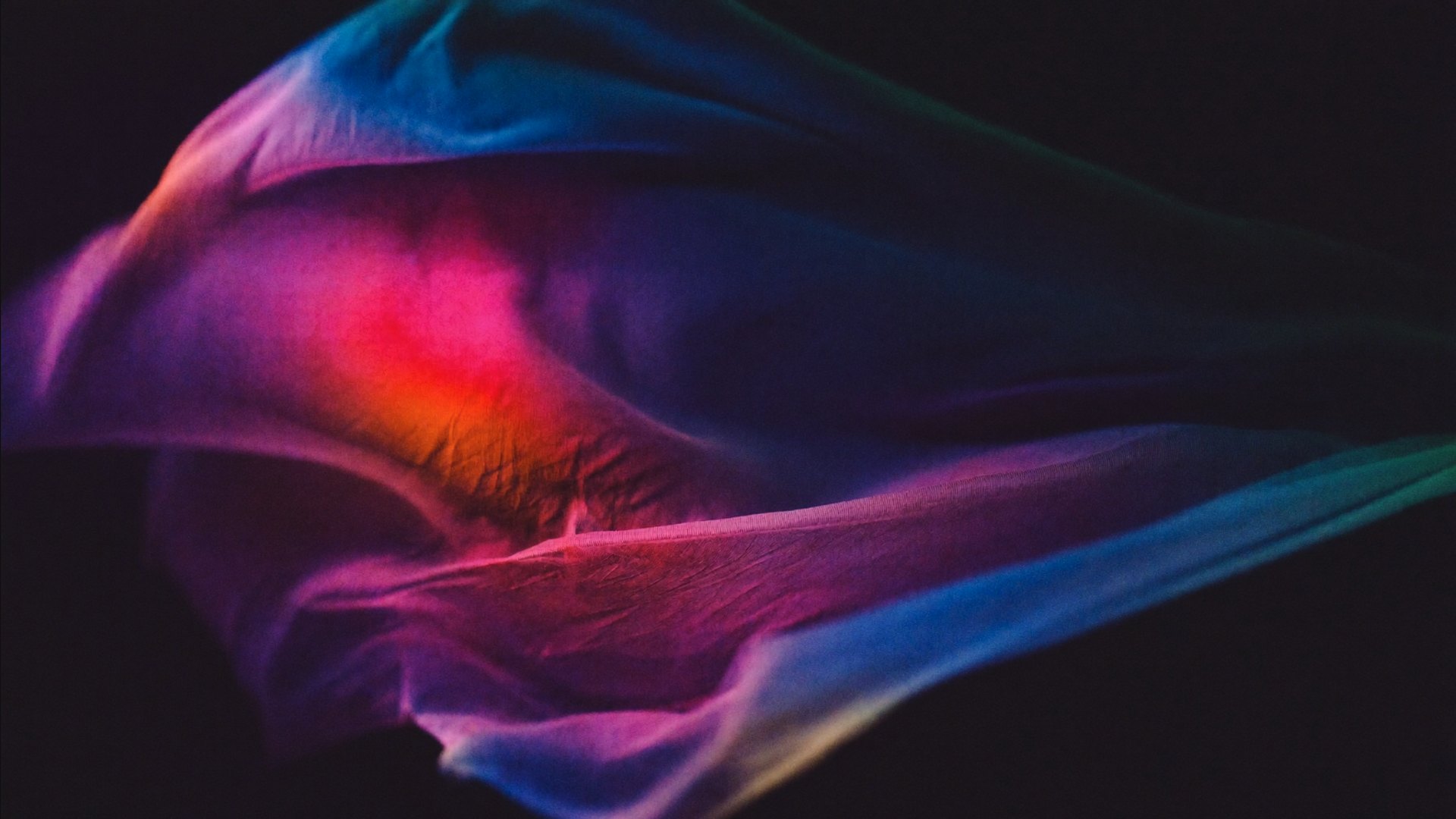 Abstract macro of backlit lighting gels in magenta and cyan